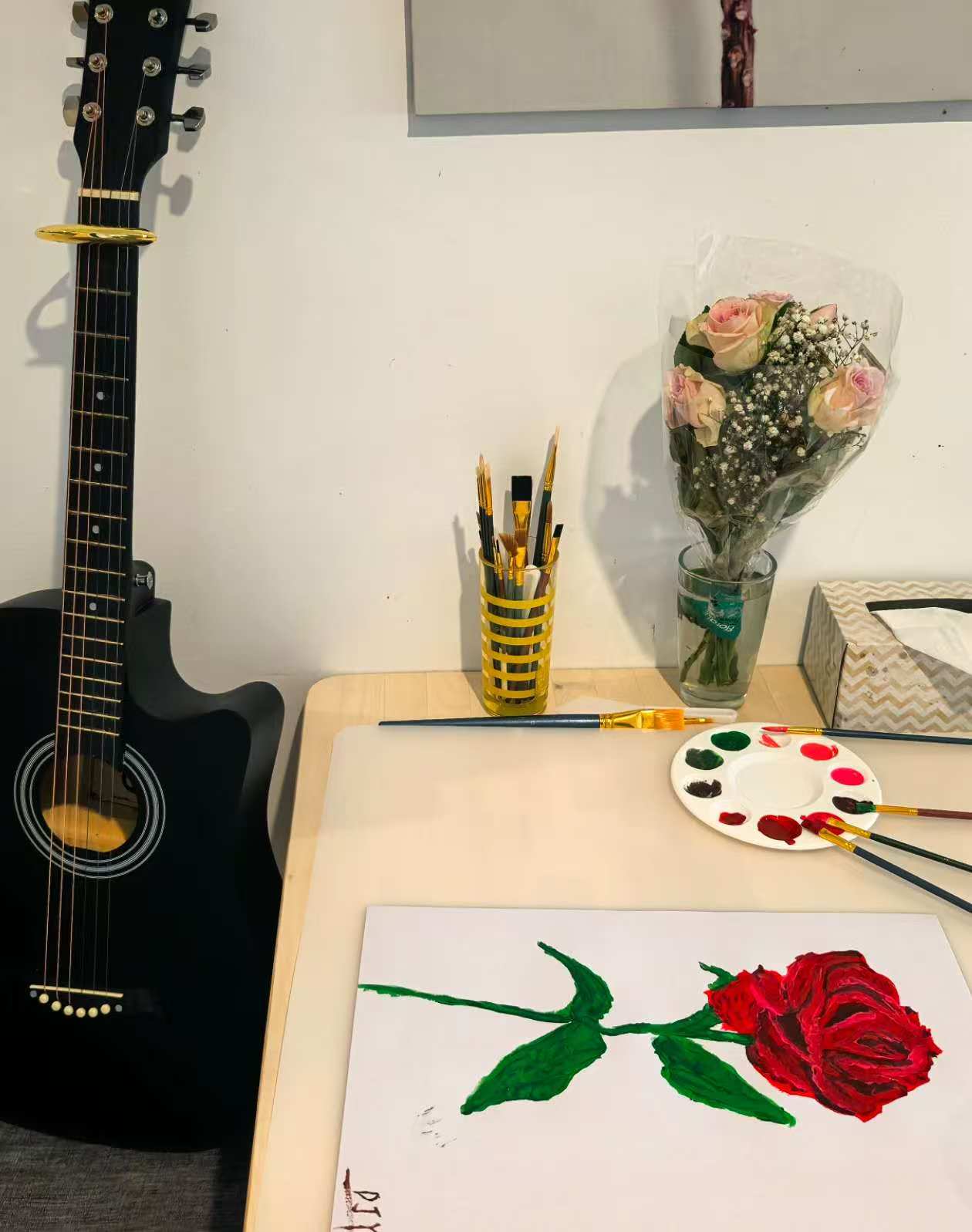 My black acoustic guitar and a watercolor painting of a red rose